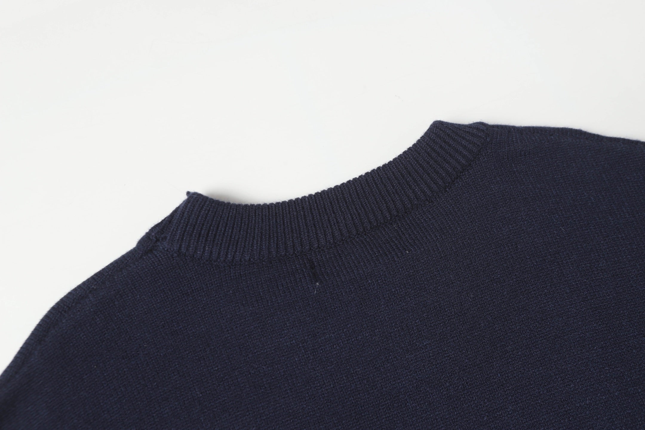 Dark navy crewneck knit sweater with ribbed collar and shoulder detail.