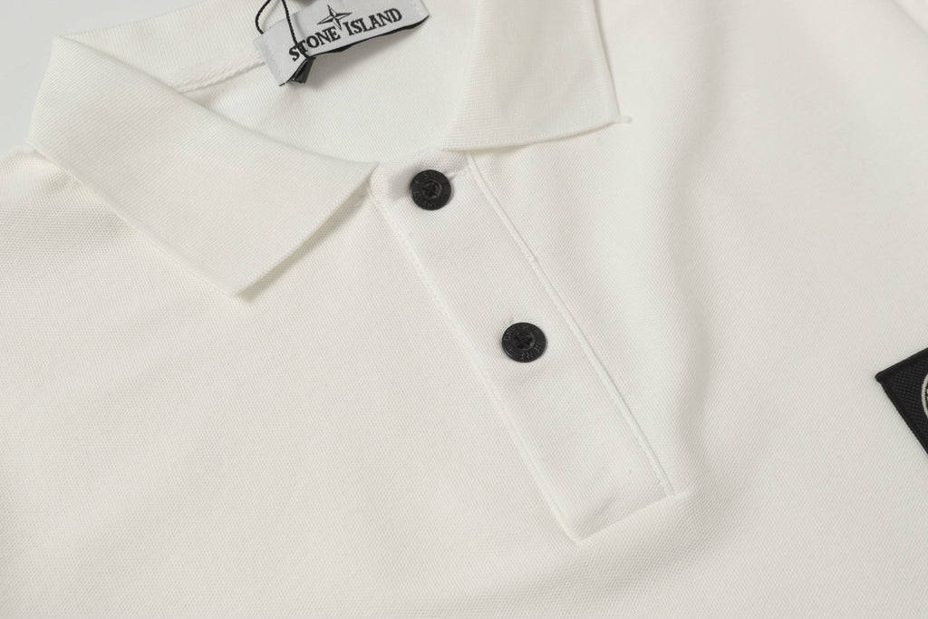 White polo shirt chest area with black buttons and stitched placket detail