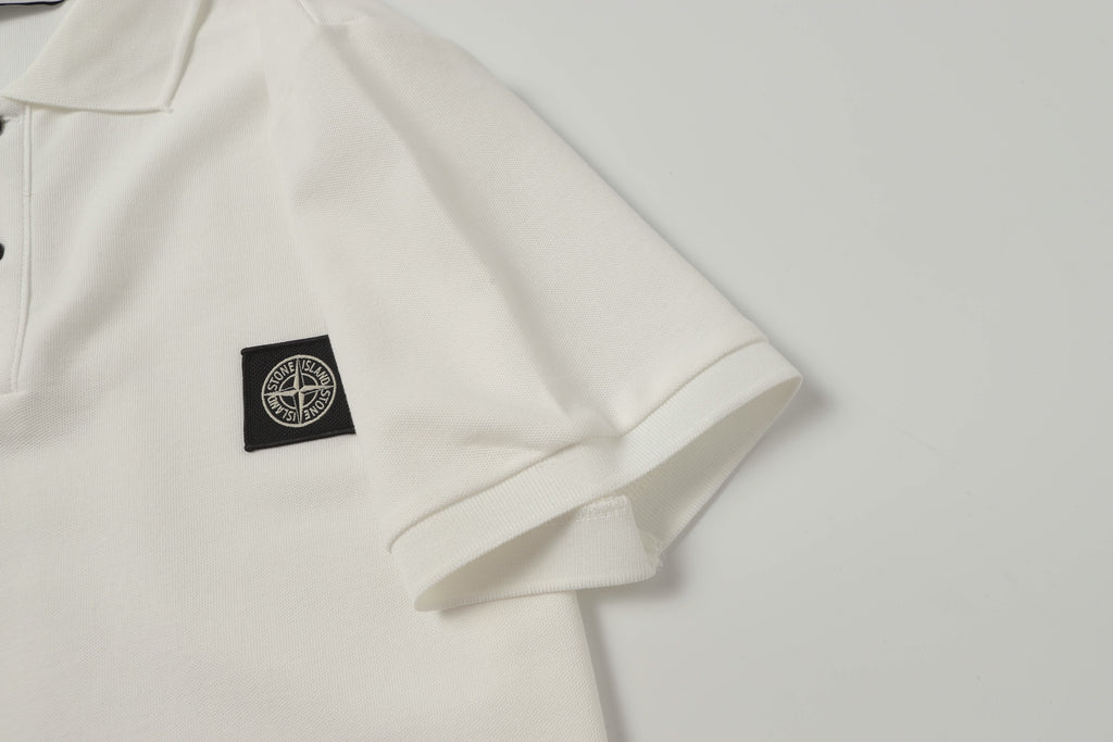 White polo shirt with small black logo patch at left chest
