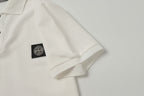 White polo shirt with small black logo patch at left chest