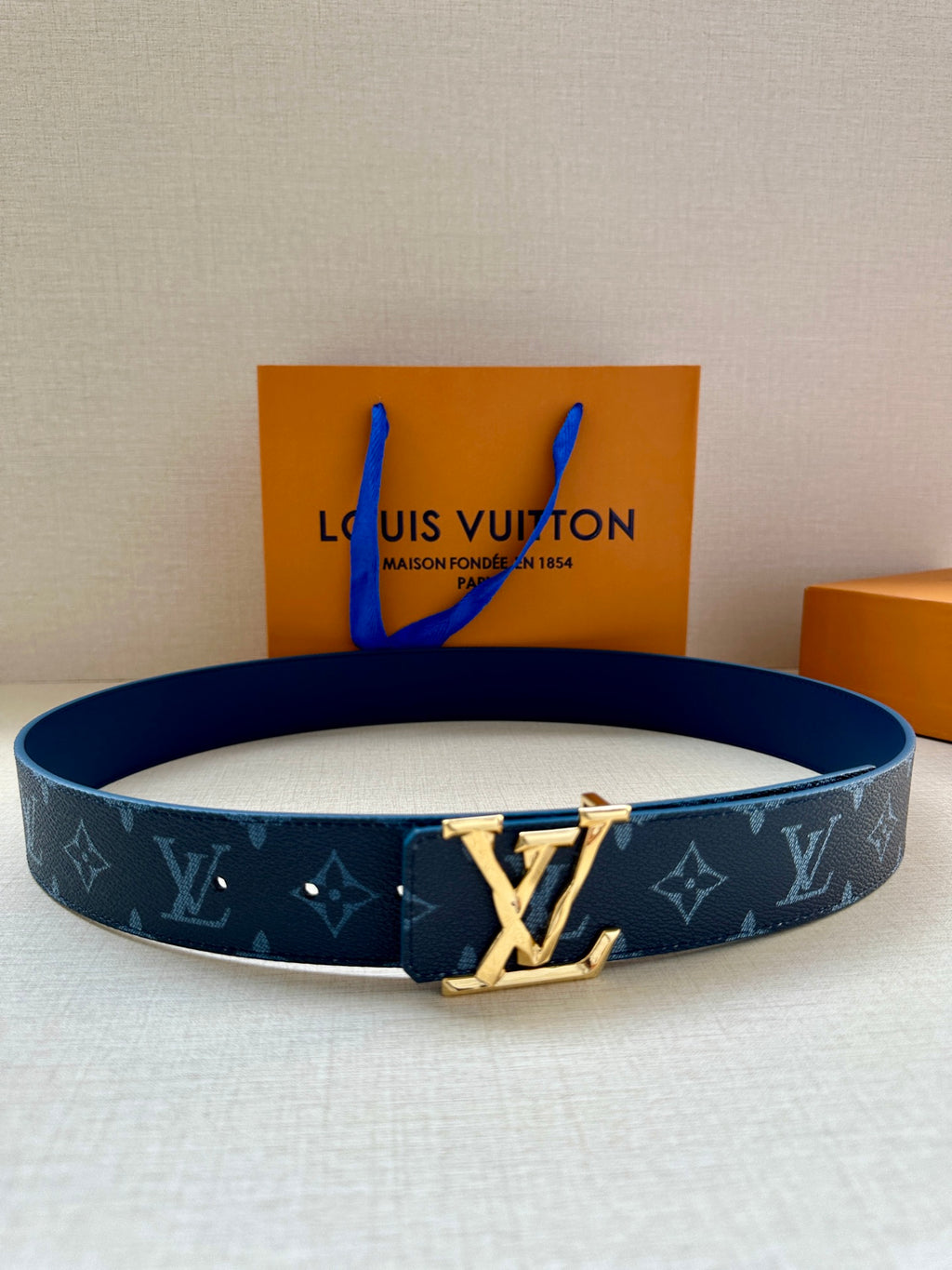 Louis Vuitton monogram belt in dark blue with gold-tone LV buckle and keeper