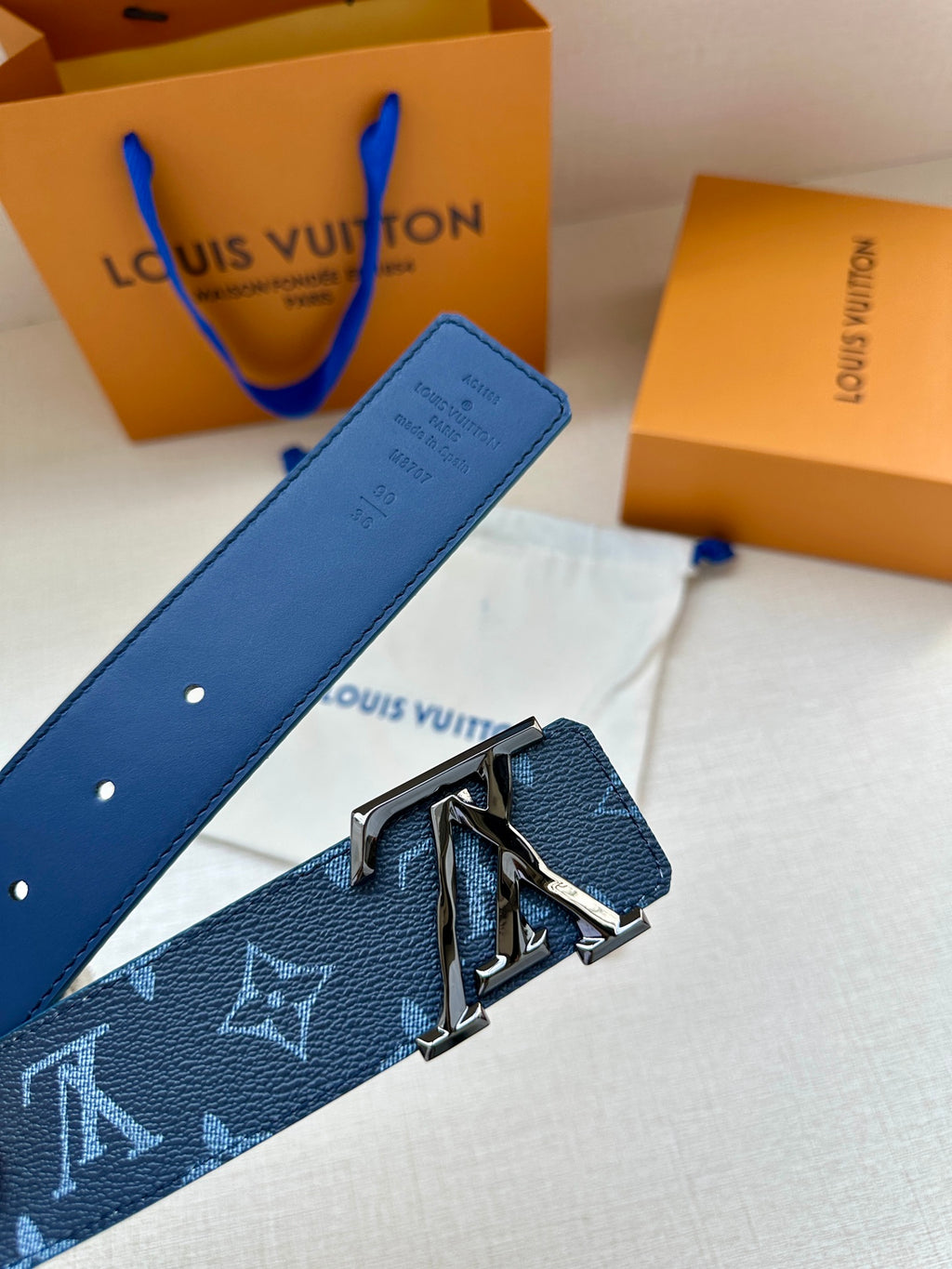 Louis Vuitton dark blue belt with monogram pattern and metal LV buckle on strap