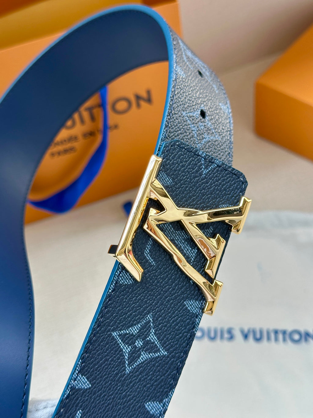 Louis Vuitton dark blue leather belt with monogram pattern and gold buckle detail