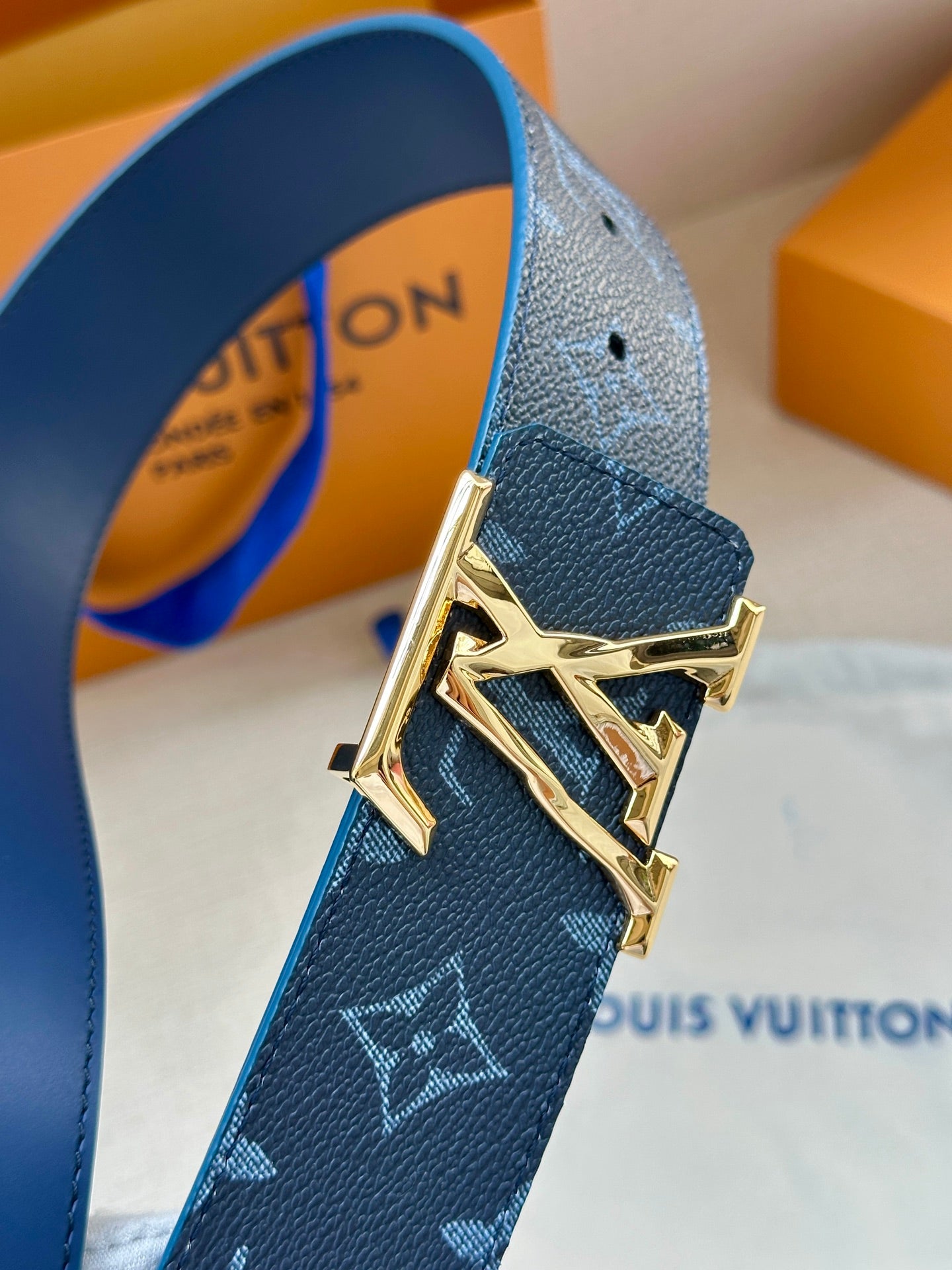 Louis Vuitton dark blue leather belt with monogram pattern and gold buckle detail