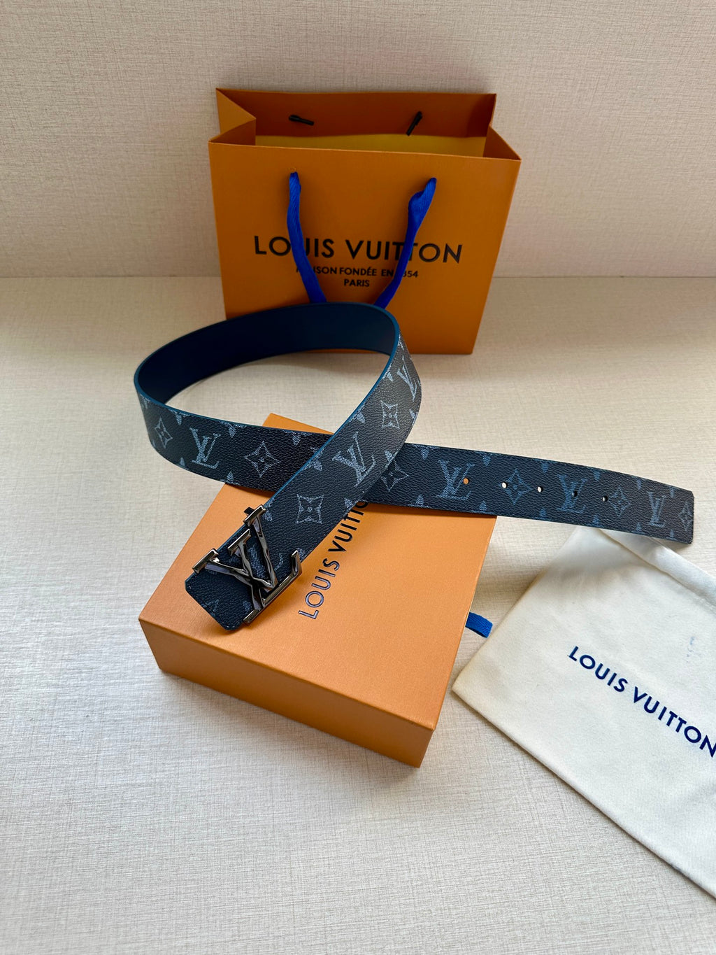 Louis Vuitton dark blue monogram belt with gold buckle and leather end strap