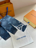 Louis Vuitton monogram belt featuring gold LV buckle with dark blue strap detail