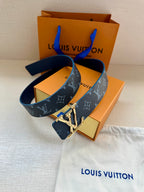 Louis Vuitton monogram belt with gold LV buckle, dark blue strap and end tab