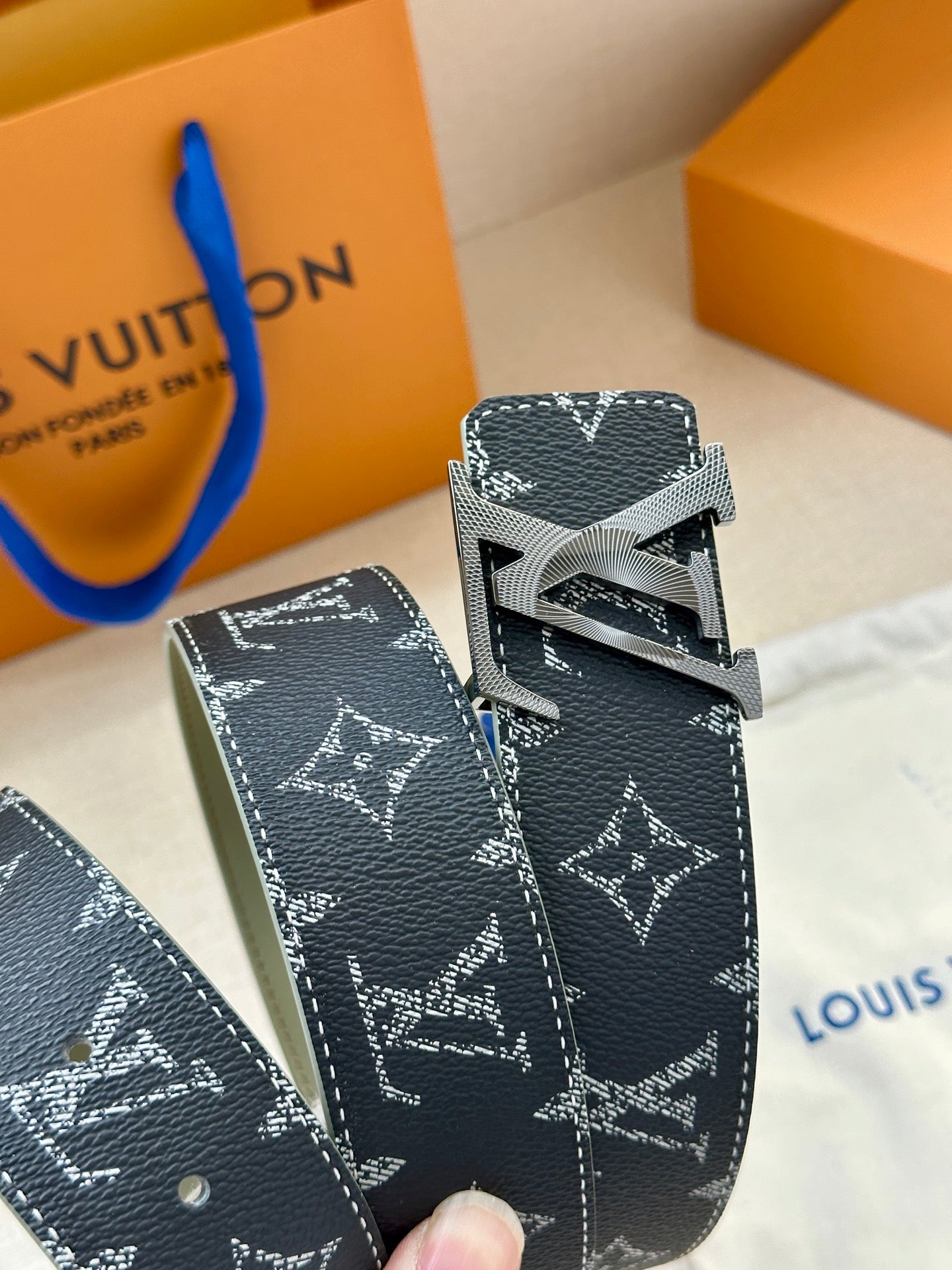 Navy Louis Vuitton monogram belt end with adjustable strap and keeper loops