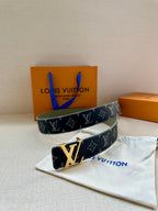 Two-view Louis Vuitton monogram belt with silver buckle, folded on cloth