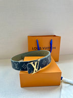 Louis Vuitton monogram belt with wide strap and silver buckle on accessory box