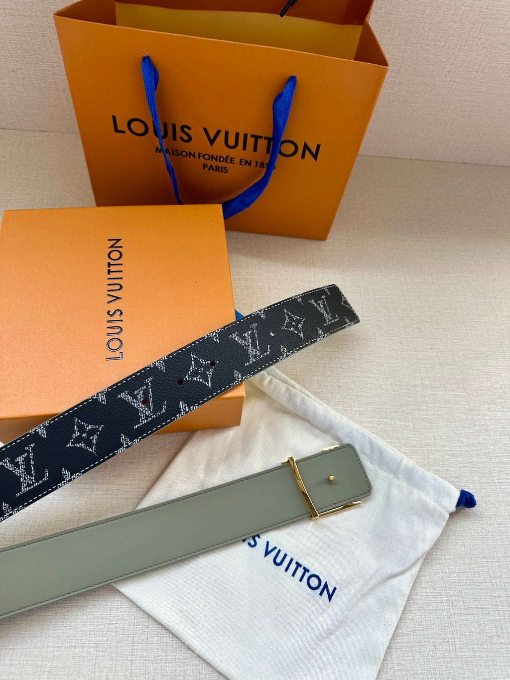 Louis Vuitton monogram belt with silver buckle and light gray inner panel