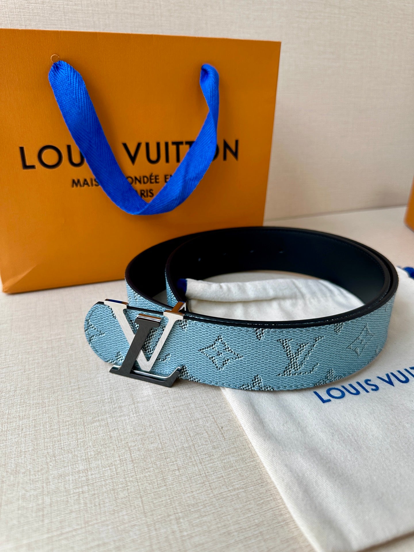 Louis Vuitton belt in blue monogram canvas with silver buckle and keeper, side view