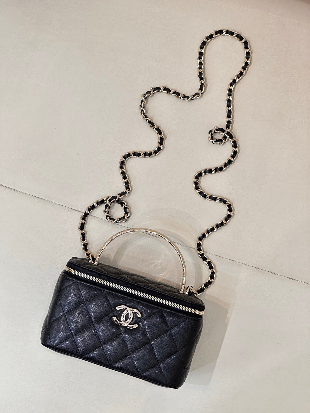 Dark navy quilted mini bag with crossbody chain strap and front CC logo emblem.