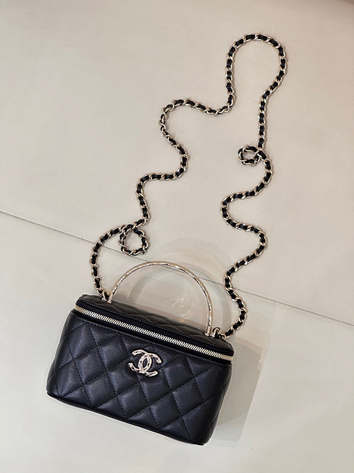 Dark navy quilted mini bag with crossbody chain strap and front CC logo emblem.