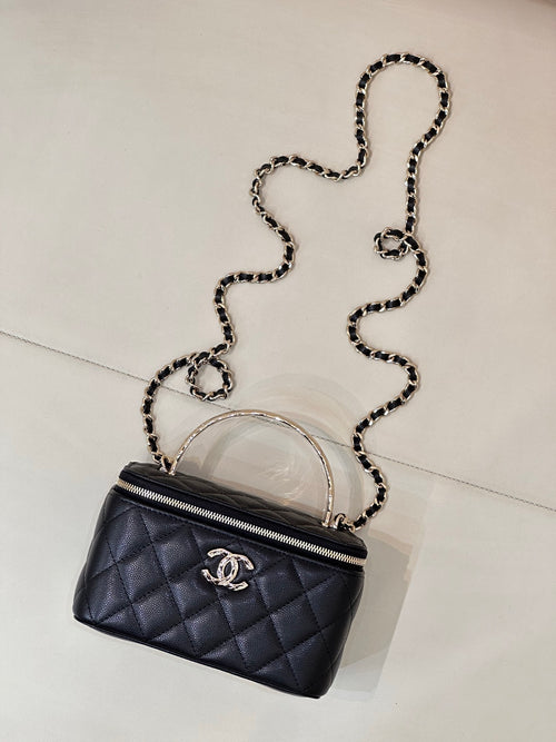 Dark navy quilted mini bag with crossbody chain strap and front CC logo emblem.