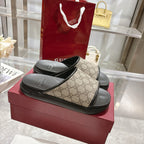 Gucci slide sandals on red box; tan GG-pattern straps with black textured footbed