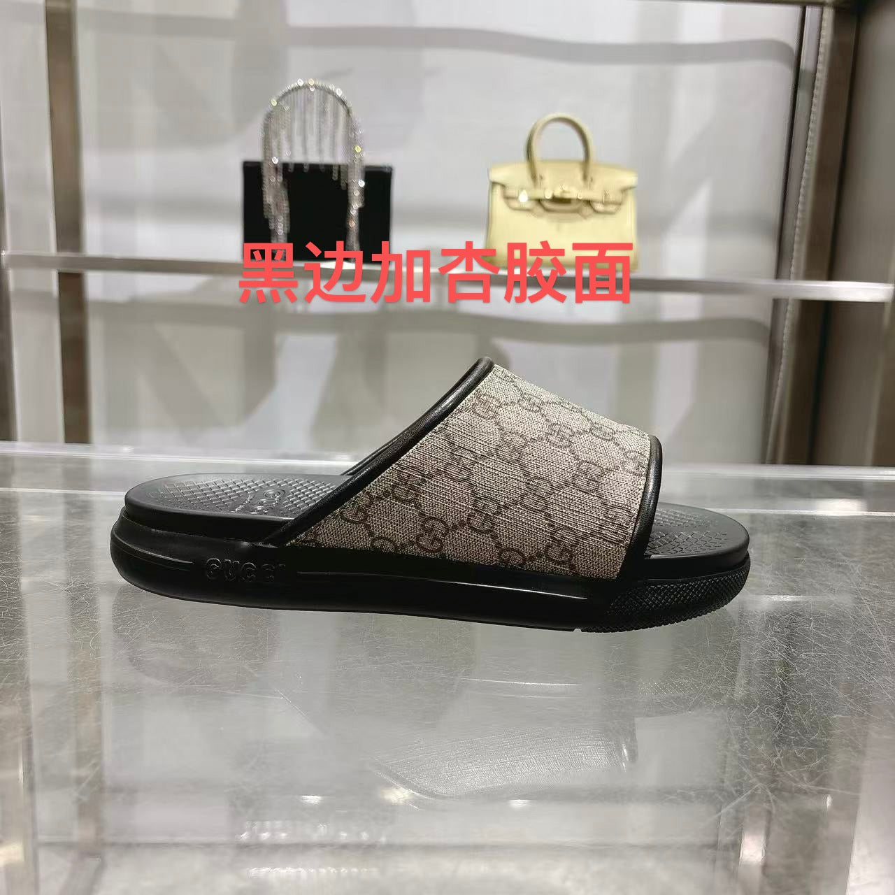 Gucci slide sandals with dark rubber sole and GG canvas upper, black strap detail