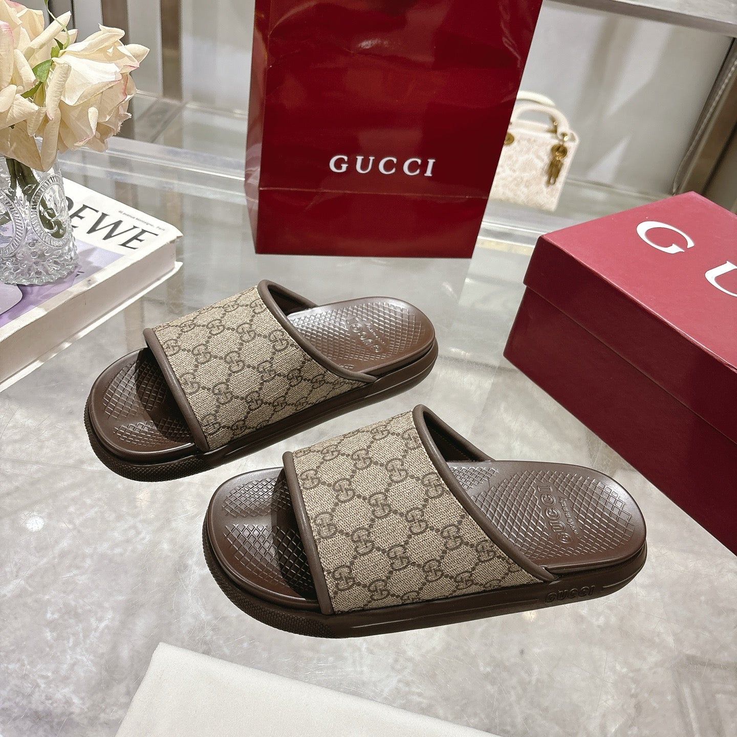Gucci slide sandals, GG canvas straps and dark contoured rubber soles