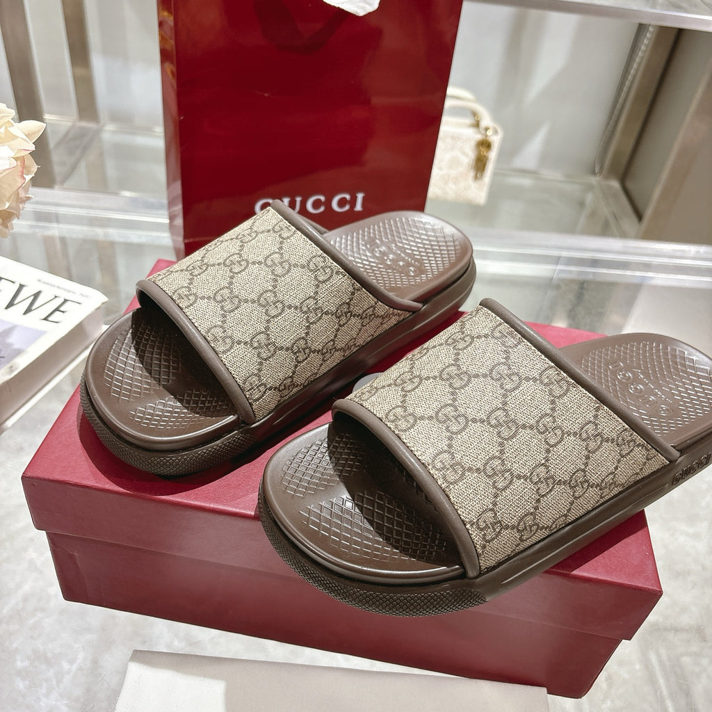 Gucci GG monogram slide sandals on stacked box, dark rubber outsole detail