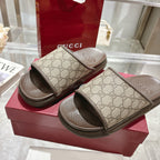 Gucci GG monogram slide sandals on stacked box, dark rubber outsole detail