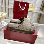 Pair of Gucci slide sandals with GG canvas straps and textured dark footbeds