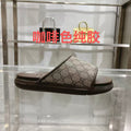 Gucci slide sandal with GG monogram canvas strap and dark rubber sole
