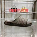 Gucci slide sandal with GG monogram canvas strap and dark rubber sole