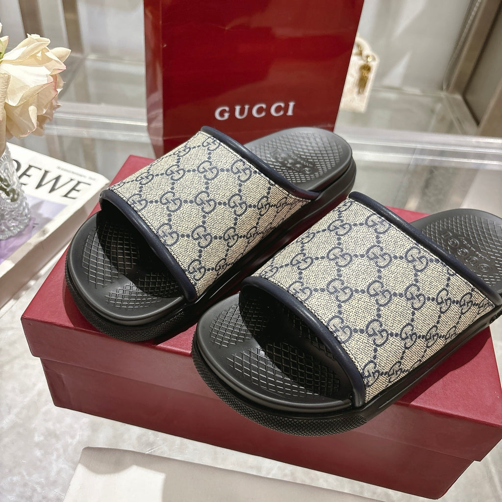 Gucci GG slide sandals on display, black footbeds and black rubber edges