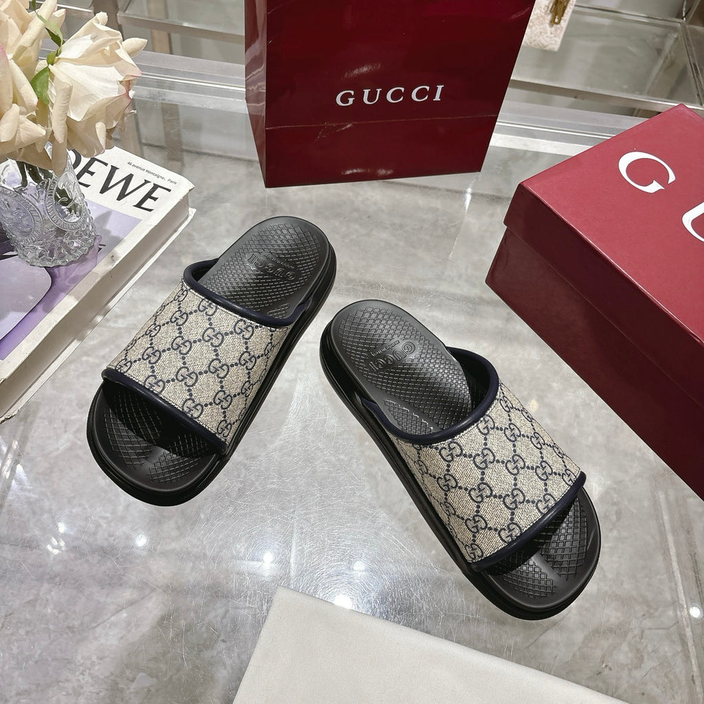 Gucci slide sandals with GG canvas straps and thick black rubber platform soles