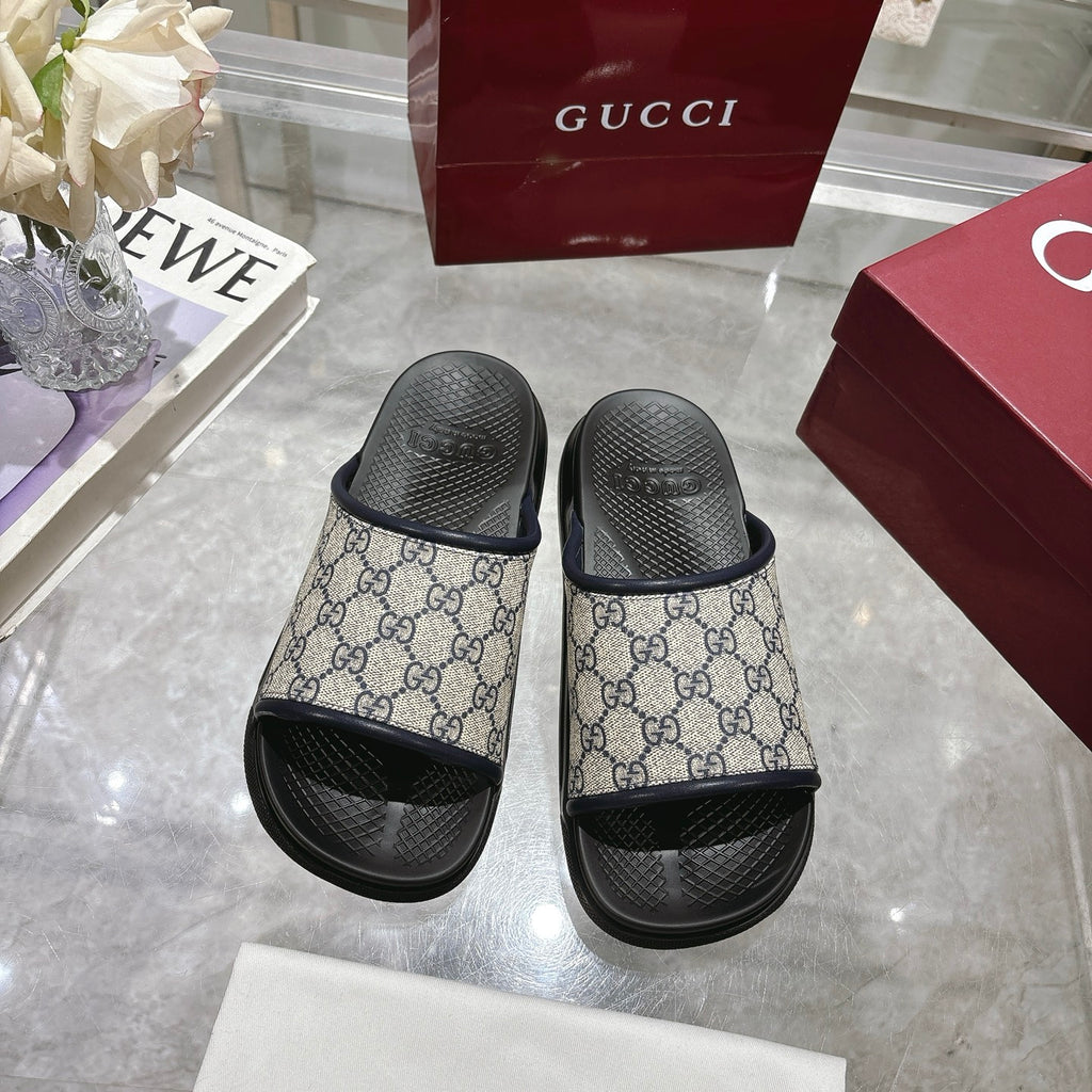 Gucci GG slide sandals, side view, showing canvas upper with black strap detail
