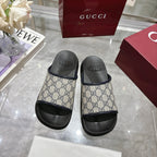 Gucci GG slide sandals, side view, showing canvas upper with black strap detail