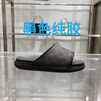 Monogram slide sandals in dark fabric with wide black strap and textured rubber sole