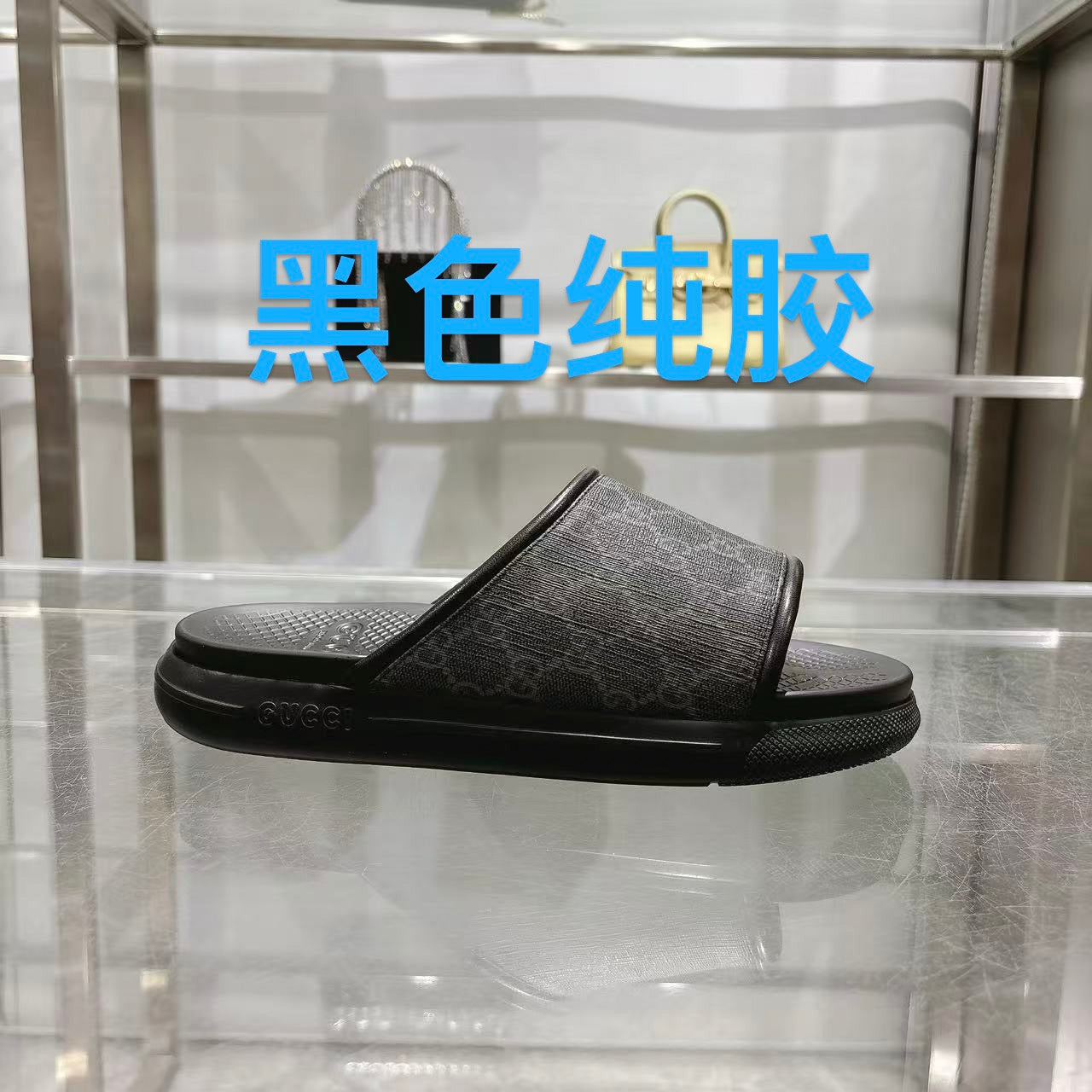 Monogram slide sandals in dark fabric with wide black strap and textured rubber sole
