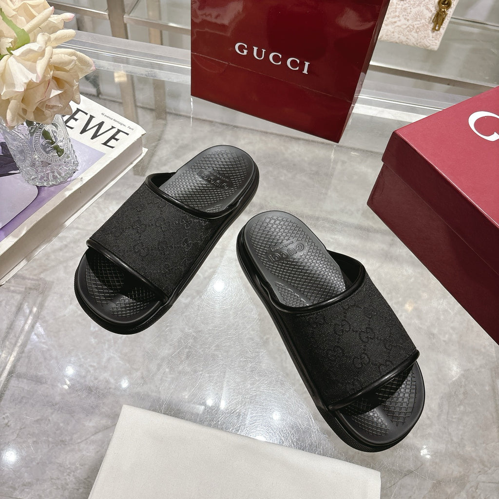 Gucci black monogram slide sandals with wide strap and molded footbed