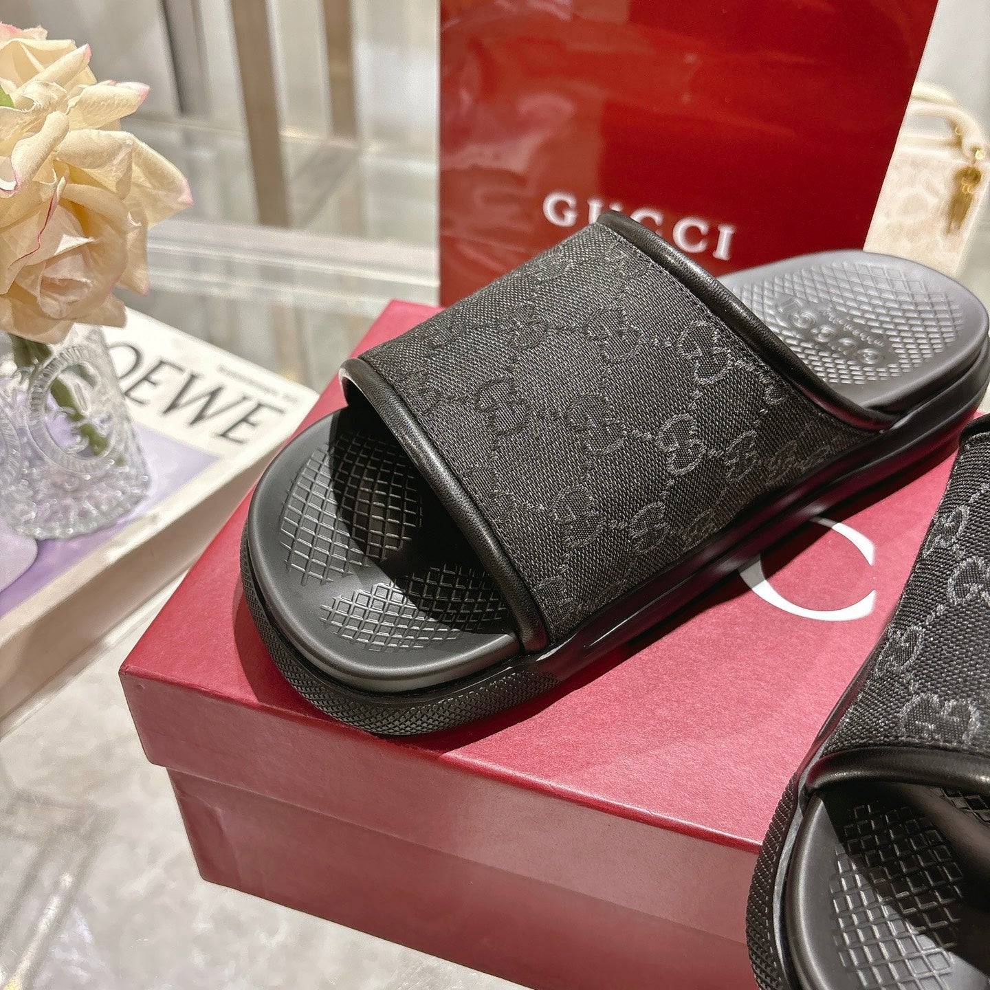 Gucci black logo slide sandals with wide strap on textured footbed