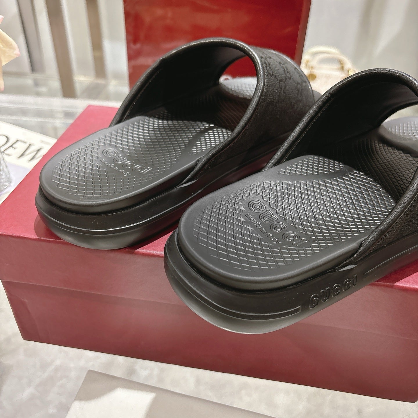 Gucci black slide sandals with textured footbeds and thick molded rubber sole