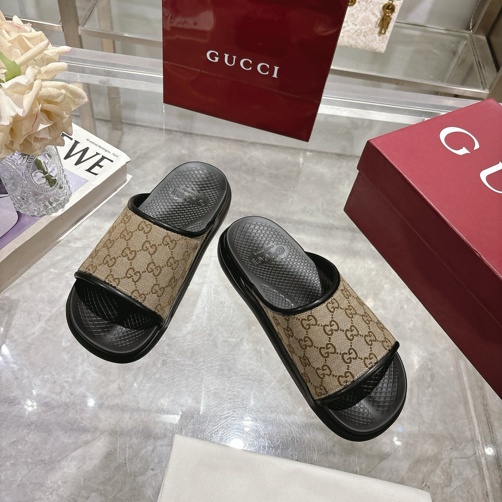 Gucci slide sandals, angled pair: beige GG canvas straps with black textured footbeds