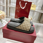 Gucci slide sandals, pair view: beige GG canvas straps with black textured footbeds