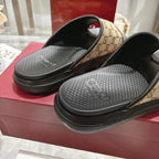 Gucci slide sandals close-up: textured black footbeds and beige GG canvas strap