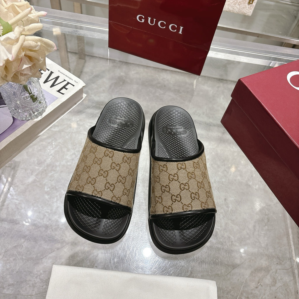 Gucci slide sandals, pair view: beige GG canvas with black rubber straps and open toe