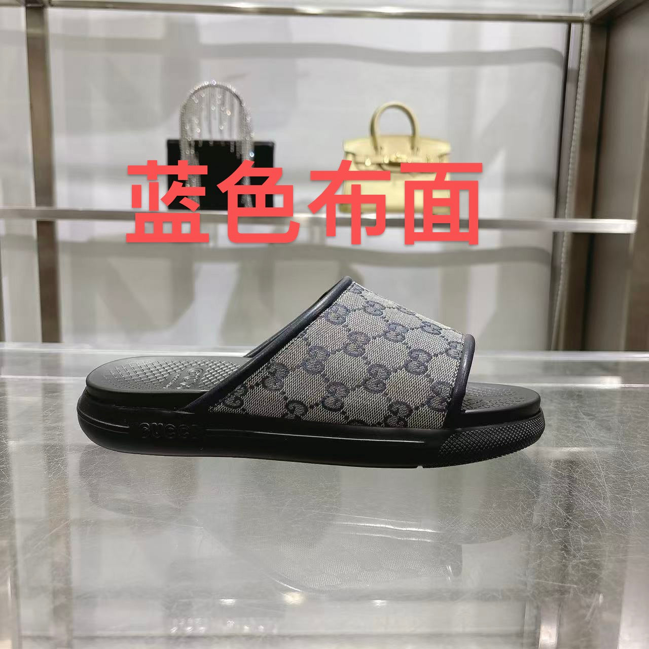 Gucci slide sandals with GG monogram strap, black rubber sole and footbed