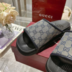 Gucci slide sandals close-up, GG monogram strap over black footbed