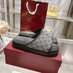 Gucci slide sandals with GG monogram strap and black textured rubber footbed