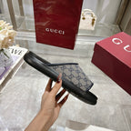 Gucci slide sandals, side view, GG monogram strap on black rubber sole