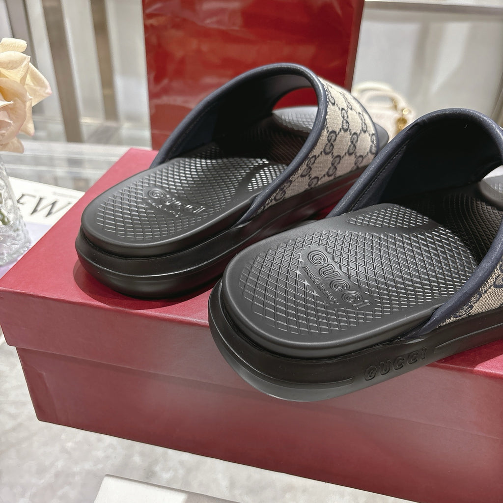Gucci slide sandals close-up, black textured footbeds and GG monogram straps