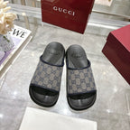 Gucci slide sandals, pair view, GG monogram straps with black rubber soles
