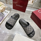 Gucci slide sandals with GG monogram straps and black textured footbeds