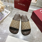 Gucci GG slide sandals pair, tan monogram straps and textured dark footbeds