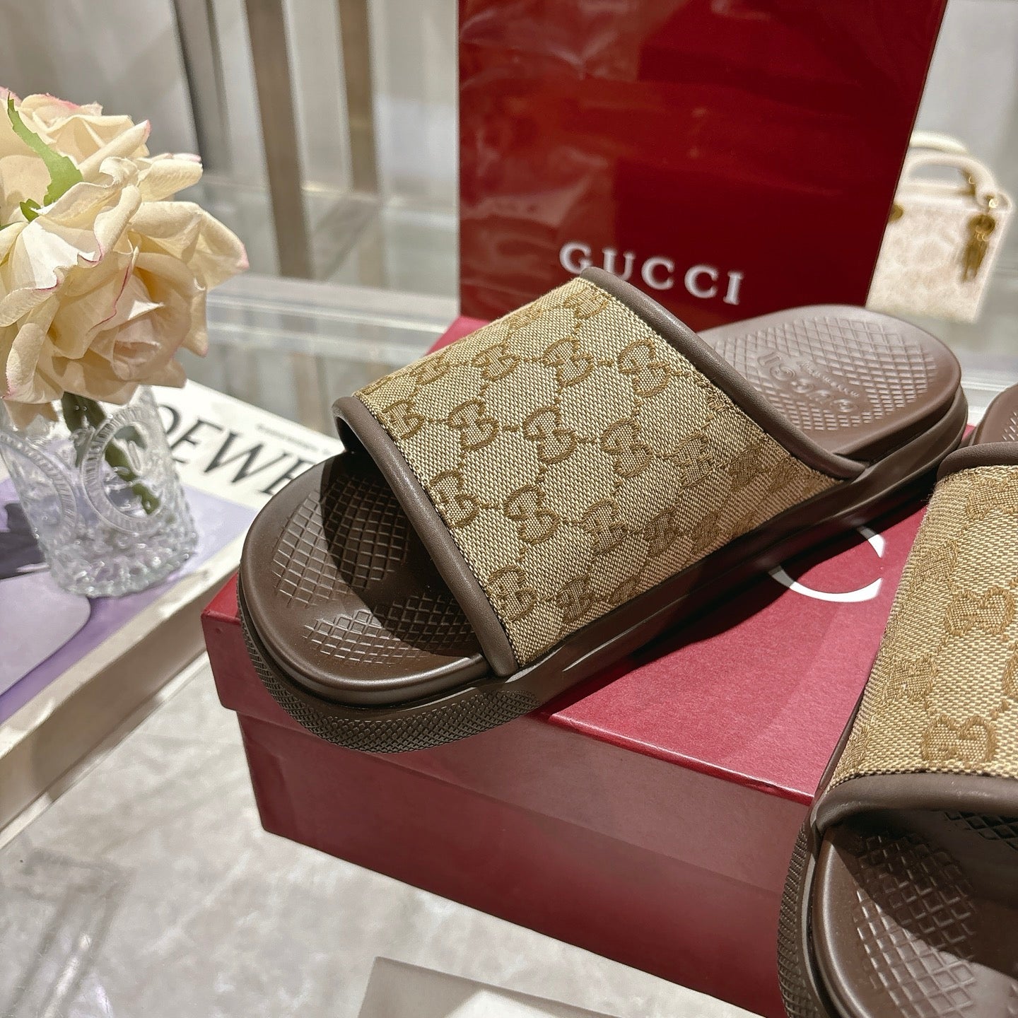 Gucci GG slide sandals, tan canvas strap and dark rubber footbed