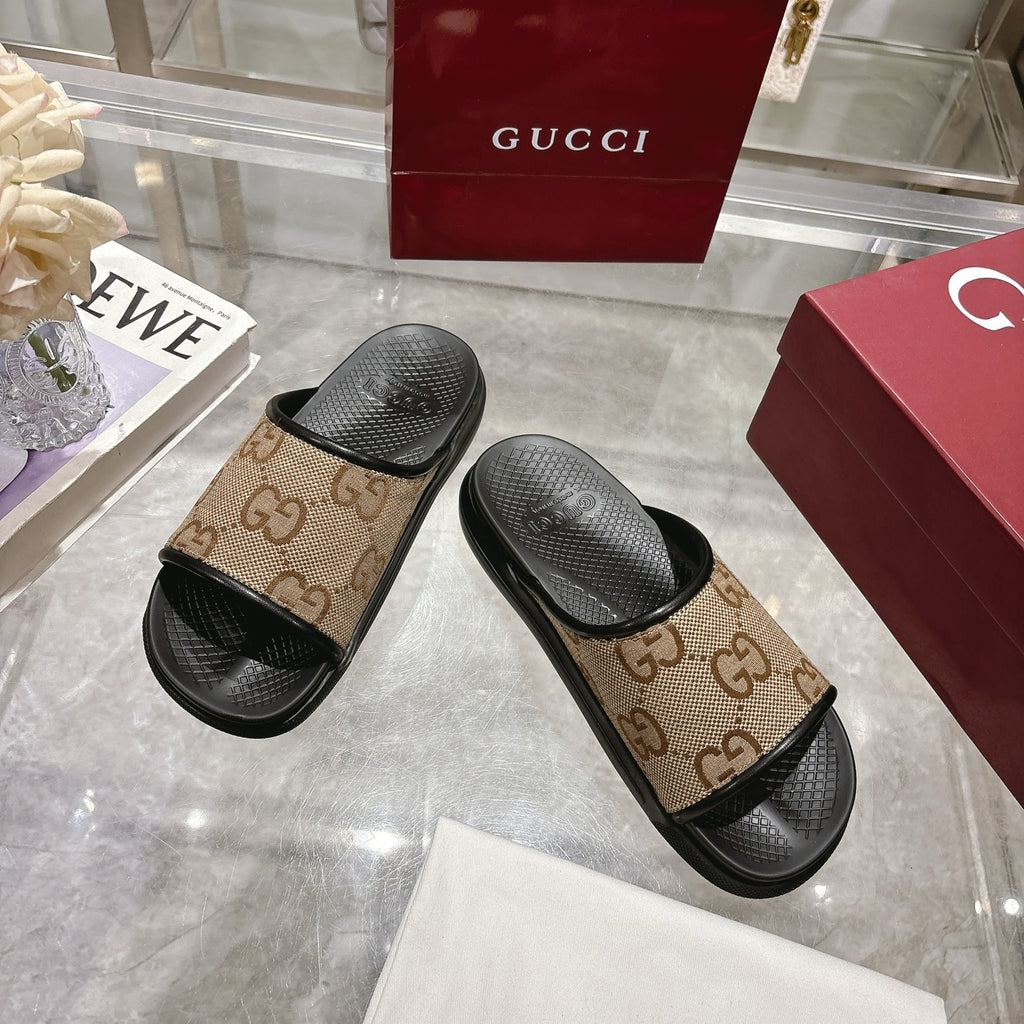Gucci slide sandals showing tan GG canvas upper with black textured footbeds